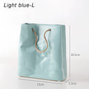 Blue large ceramic vase designed to resemble a shopping basket, featuring a patterned and transparent electric blue appearance.