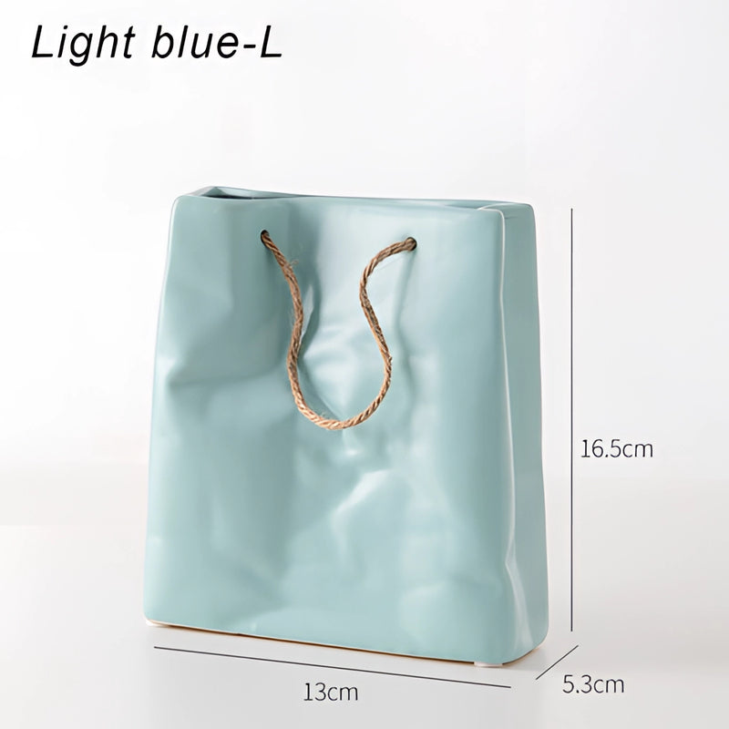 Blue large ceramic vase designed to resemble a shopping basket, featuring a patterned and transparent electric blue appearance.
