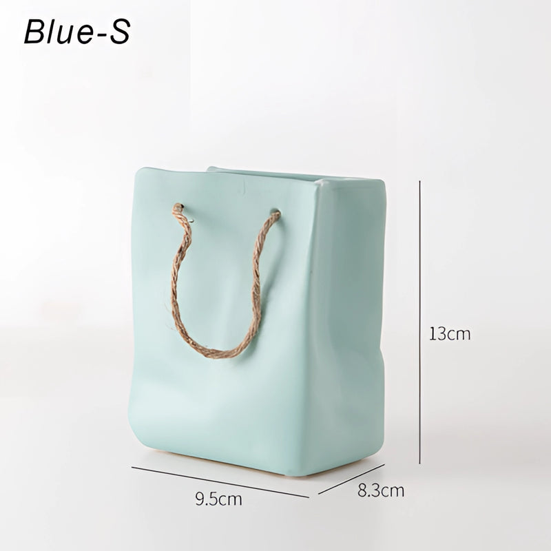 Ceramic vase designed to resemble a shopping basket, featuring rectangular and circular elements in an electric blue color.
