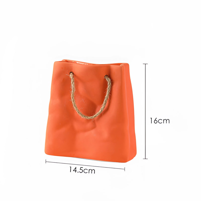 Orange large ceramic vase designed to resemble a shopping basket, featuring handle details and a textured exterior.