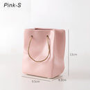 Pink small ceramic vase designed to resemble a shopping basket.