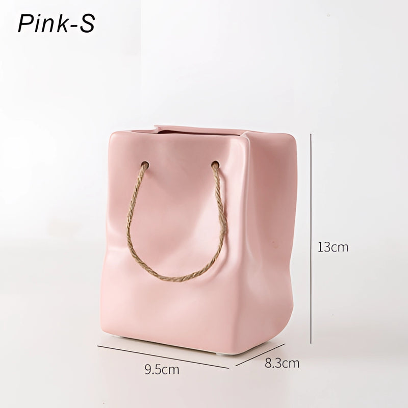 Pink small ceramic vase designed to resemble a shopping basket.