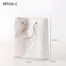 White ceramic vase featuring a unique shopping basket design, with elements resembling metal and glass, and circular and rectangular shapes depicted artistically.