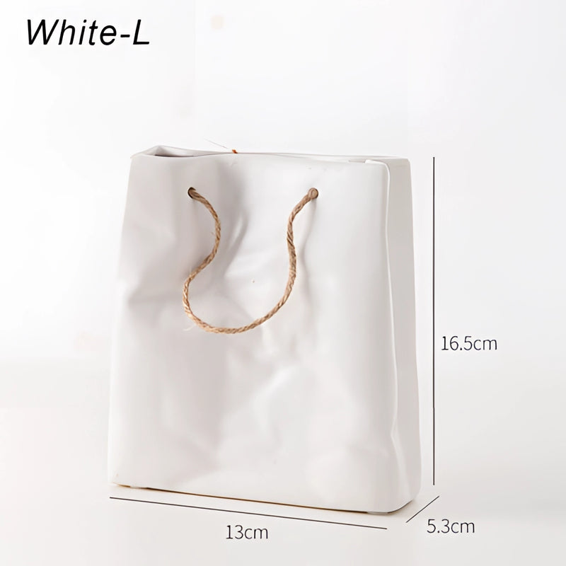 White ceramic vase featuring a unique shopping basket design, with elements resembling metal and glass, and circular and rectangular shapes depicted artistically.