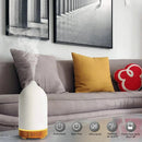 Ceramic wood grain aromatherapy diffuser with a 7-color night light in a living room setting, placed on a white couch.