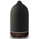 Black ceramic wood grain aromatherapy diffuser with 7-color night light, cylinder-shaped with a metallic cap.