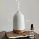 Ceramic wood grain aromatherapy diffuser with a 7-color night light, designed to look like a glass bottle, displaying various liquid contents.