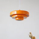 Modern metal pendant lamp featuring linked circles design in amber, installed on a ceiling with a lampshade, capable of switching between three color temperatures.