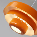 Modern linked circles pendant lamp featuring an amber orange hue with a metallic finish and artistic design elements.