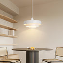 White metal modern linked circles pendant lamp with three color temperature settings, displayed over a wooden table in a well-lit interior setting.