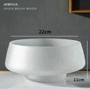 Coffee-colored frosted glass vase on a table, featuring a transparent and slightly textured finish.