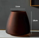 Coffee-colored frosted glass vase in variant Coffee color B, displayed on a wooden surface with soft lighting overhead.