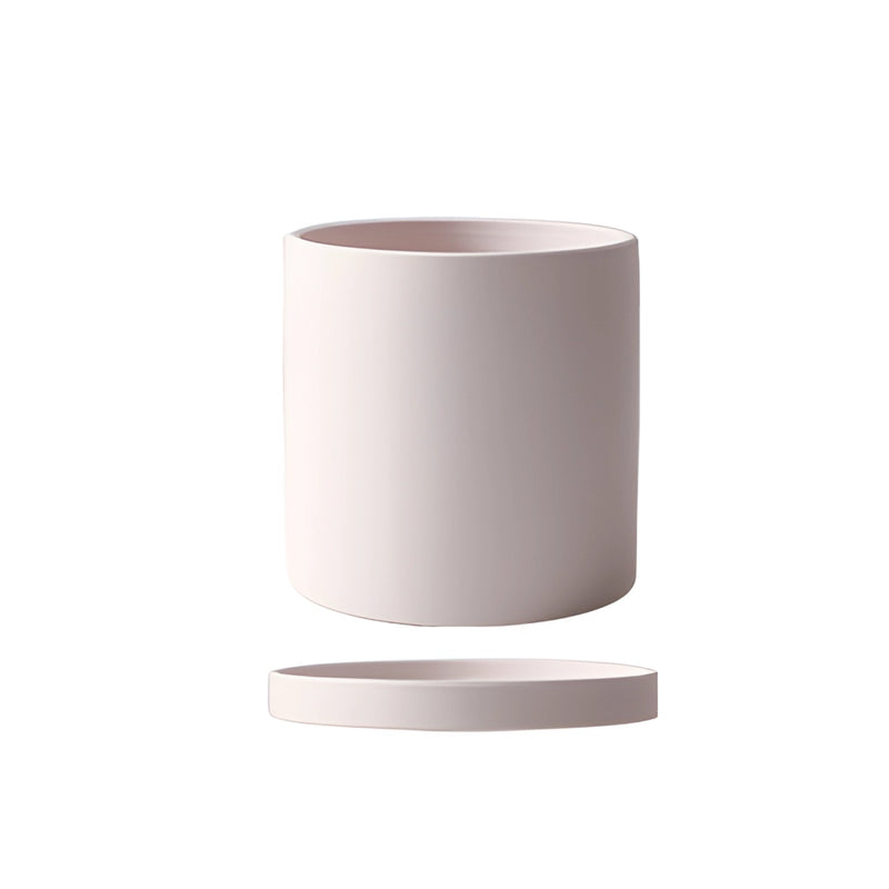 Beige ceramic planter with saucer set on a table, featuring a cylindrical shape and circular design elements.