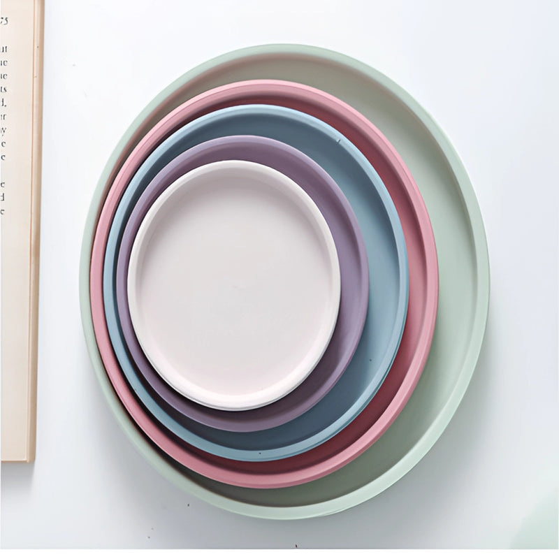 Colorful ceramic planter and saucer set displayed as dishware, featuring intricate designs in porcelain-like style.