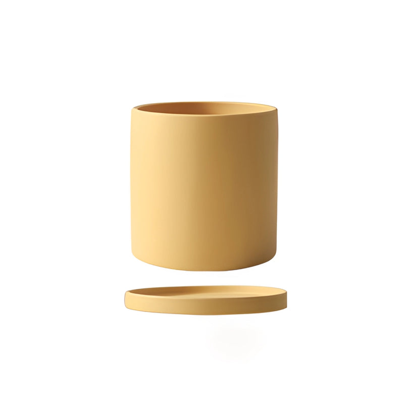 Ochre yellow ceramic planter and saucer set, featuring a cylindrical shape with a matching rectangular saucer, displayed on a wooden surface.