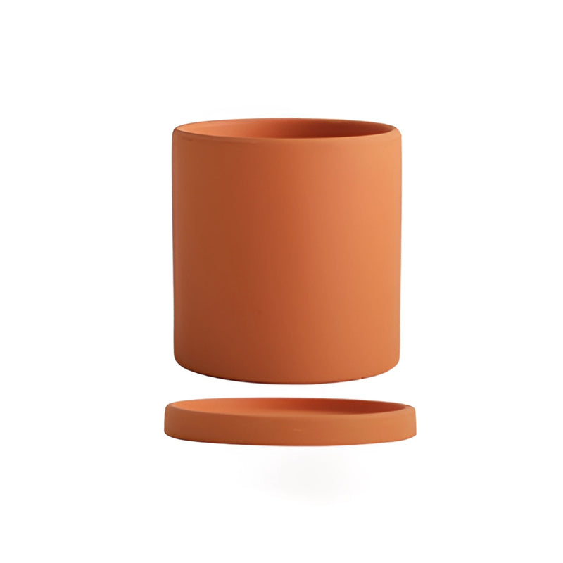 Large orange ceramic planter with a matching saucer, featuring a cylindrical shape and vibrant magenta and electric blue accents.