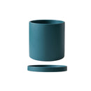 Colorful ceramic planter and saucer set in teal, featuring a cylindrical shape with a vibrant electric blue tone, designed to resemble drinkware.
