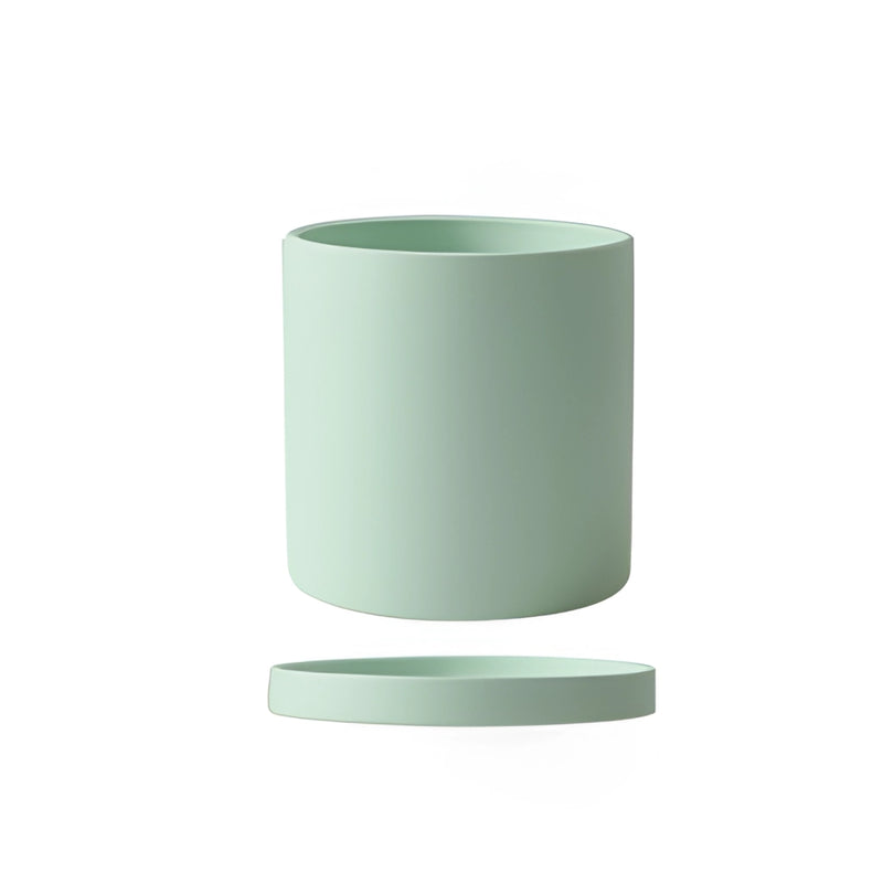 Mint-colored large ceramic planter and saucer set displayed on a table.