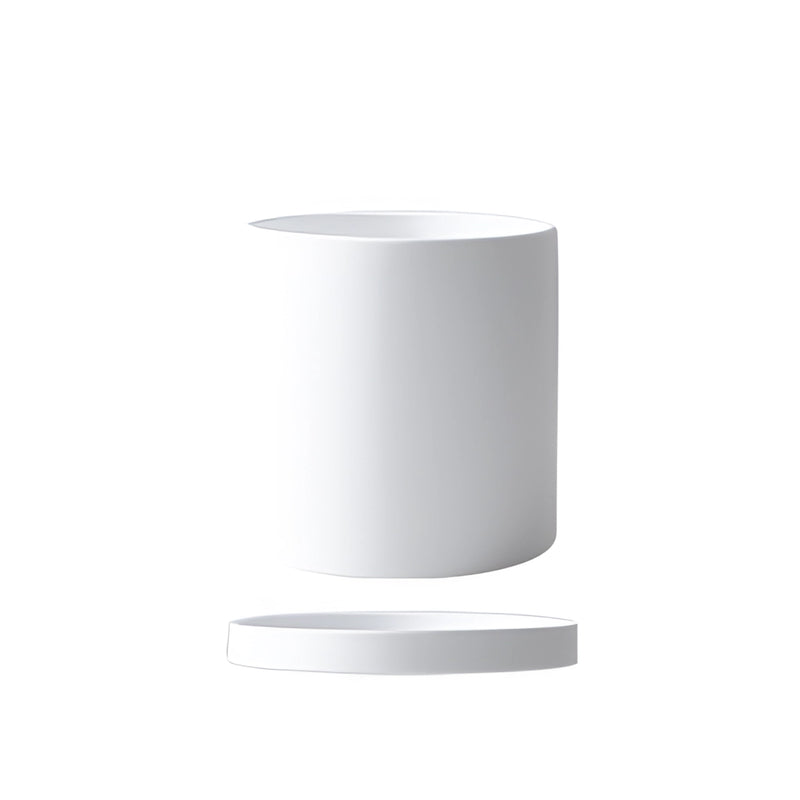 White large ceramic planter with a matching saucer, featuring a cylindrical shape and circular design elements, suitable for indoor plants.