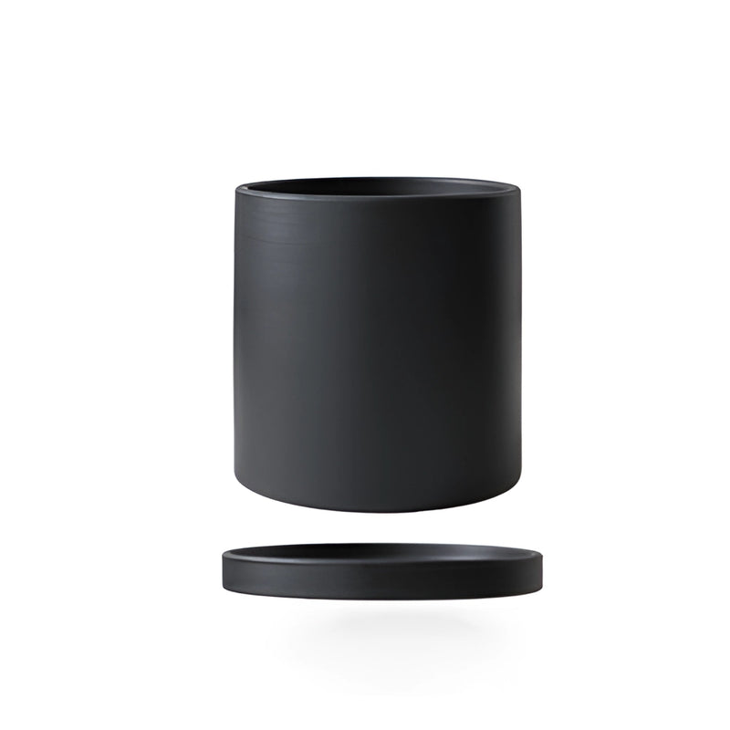 Colorful ceramic planter and saucer set in black, displayed on a table, mislabeled as audio equipment and drinkware.