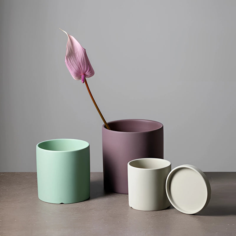 Colorful ceramic planter with matching saucer set, featuring a floral design, displayed on a table.