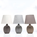 Contemporary rechargeable table lamp featuring a unique style with grey tints, art-inspired design, wood elements, and a combination of circular and rectangular shapes.