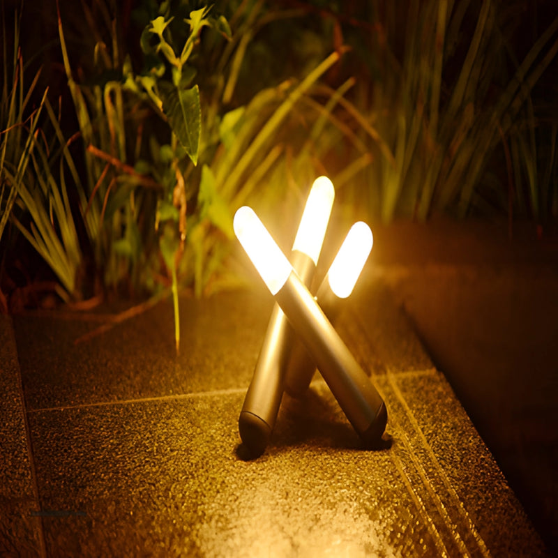 LED table lamp featuring a kinetic rotation design, placed on a wooden surface surrounded by plants under sunlight.