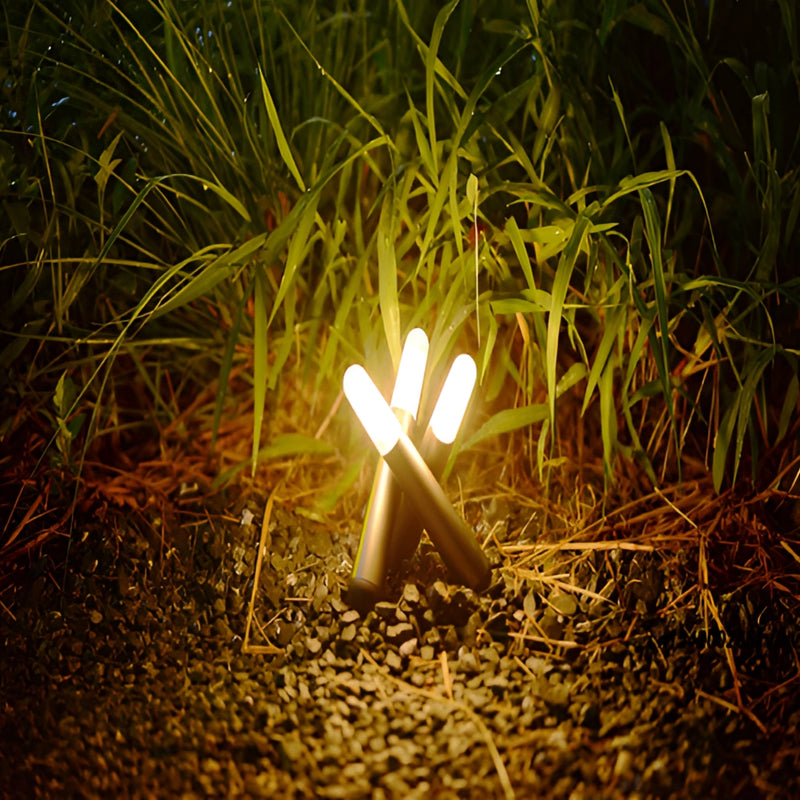 Cordless Kinetic Rotation LED Table Lamp displayed outdoors with plants, branches, and grass in natural sunlight.