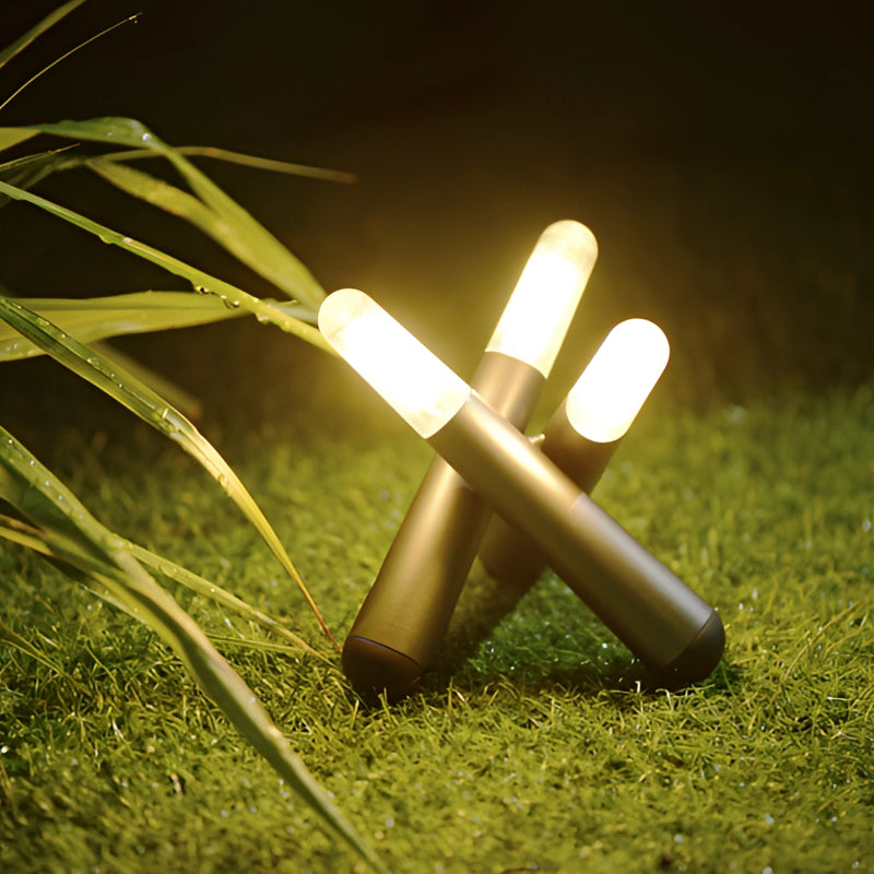 Cordless kinetic rotation LED table lamp placed on a wooden surface in a grassy meadow with a person interacting using gestures.