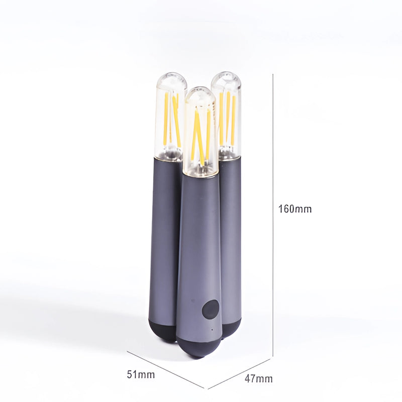 Cordless kinetic rotation LED table lamp featuring a cylindrical shape with metal body in electric blue and magenta, resembling audio equipment.