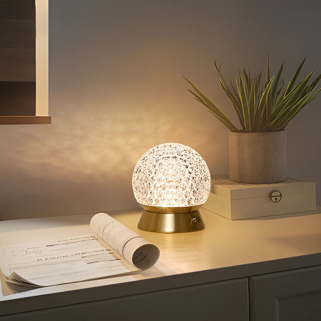 Modern designed cordless rechargeable LED dimmable table lamp placed on a wooden table beside a couch, with a houseplant in the background enhancing the interior lighting.