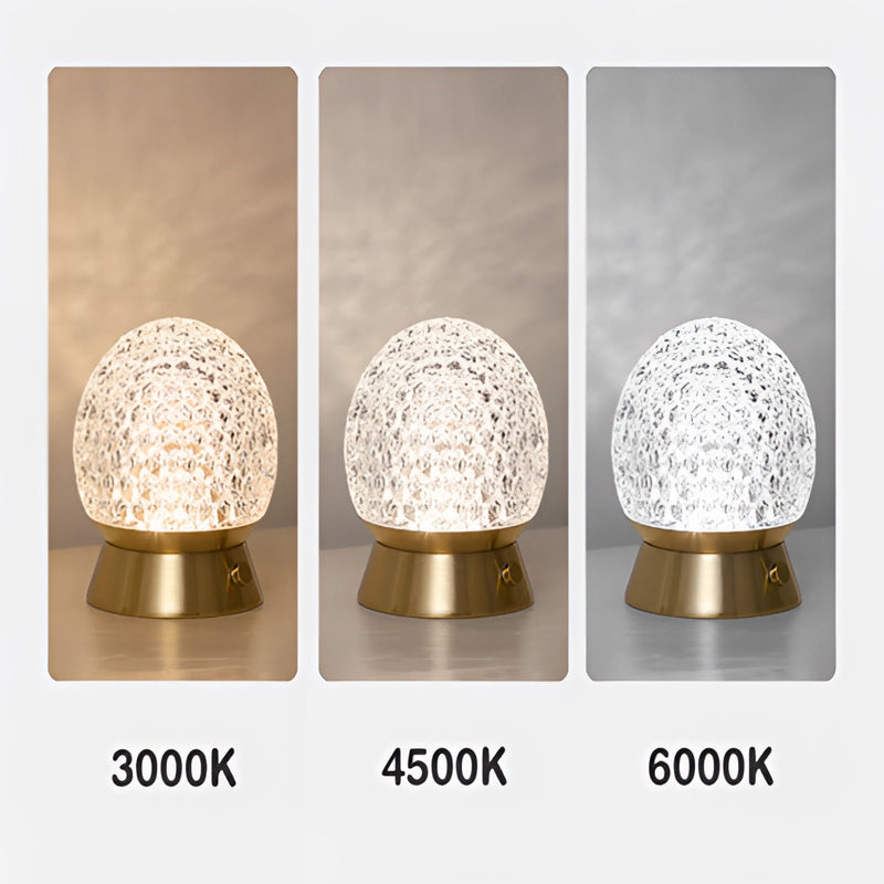 Modern design cordless rechargeable table lamp featuring a dimmable LED light, with a sleek metallic body incorporating natural materials and decorative oval and circle elements.