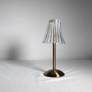 Cordless table lamp featuring a blend of natural wood, metal, and glass materials, designed with artistic sculpture elements and circular accents.