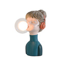 Resin desk lamp in a chic minimalist design, featuring an abstract human form in orange and green colors.