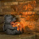 Dragon-shaped LED table lamp displayed on a brickwork surface, artistically blending wood elements with water motifs, creating a sculpture-like appearance with various tints and shades.