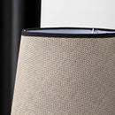 Grey elephant-shaped lamp on a wooden table, designed with composite materials and subtle shades, featuring a rechargeable battery.