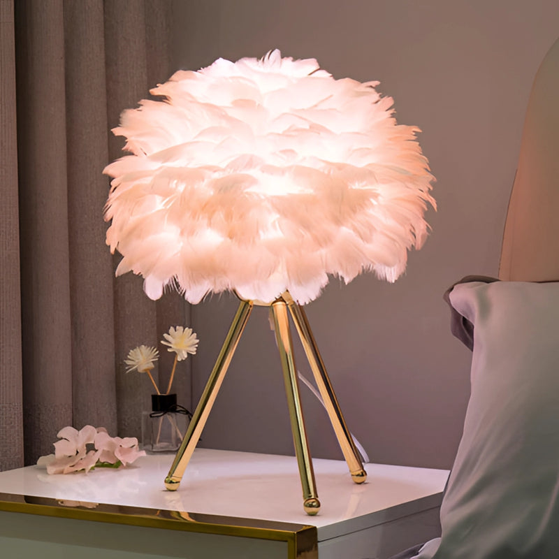 Feather LED Table Lamp with dimmable lighting, displaying artificial flowers on a table, featuring textiles and a vase in shades of gray.
