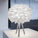 Feather LED table lamp featuring natural material design with petal and feather accents, set on a rectangular base, providing dimmable lighting in shades of white.
