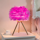 Purple and pink feather LED table lamp with dimmable lighting, showcasing a floral and textile design on a table.