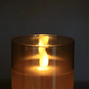 Three-piece flameless glass candle set featuring LED pillar candles with an amber glow, displayed without any visible flames or heat, controlled by a remote.
