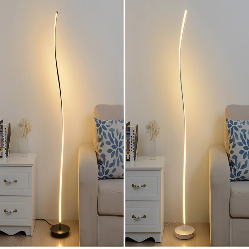 Modern floor lamp with remote control featuring three light temperature settings, positioned in a cozy interior with wooden furniture including a chest of drawers and dresser.
