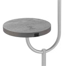 Modern floor lamp featuring a wireless charging station and an integrated table top shelf, constructed from metal and aluminum with circular and rectangular design elements.