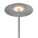 Floor lamp featuring a wireless charging station and an integrated table top shelf, with a metal structure and lampshade, illuminated by a light bulb.