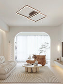 Modern artistic geometric aluminum pendant light featuring LED technology, displayed in a stylish interior with wood flooring, plants, and comfortable furnishings.