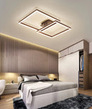 Modern artistic geometric aluminum pendant light featuring LED technology, displayed in a room with wooden flooring and comfortable furnishings.