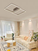 Modern artistic design geometric aluminum pendant light with LED technology, displayed in a well-lit living room featuring wood flooring, a yellow decorative theme, and a plant.