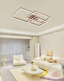 Modern artistic design geometric aluminum pendant light with LED technology, displayed over a wooden table in a stylishly decorated interior with architectural elements.