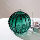 Small green glass cactus vase with intricate details resembling holiday ornaments.