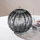 Small gray glass cactus vase with a symmetrical and artistic design.