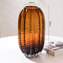 Large brown glass cactus vase with an amber hue, designed to resemble a light fixture or pottery art piece.